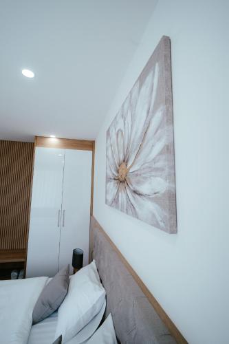 a bedroom with two beds and a painting on the wall at Hotel Park in Valpovo