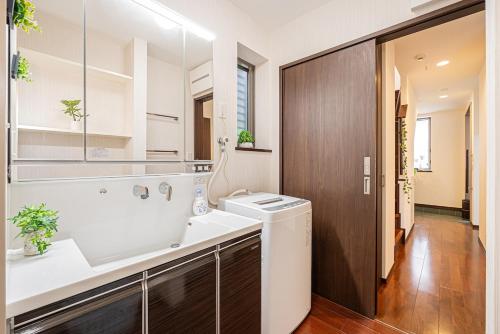 un bagno con lavandino e lavatrice di Fukuei Stay Premium a Tokyo