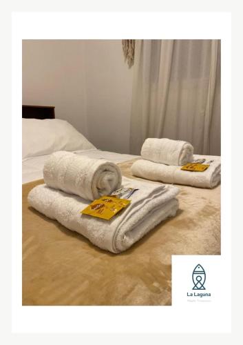 two towels sitting on top of a bed at La Laguna Cruz del Eje in Cruz del Eje