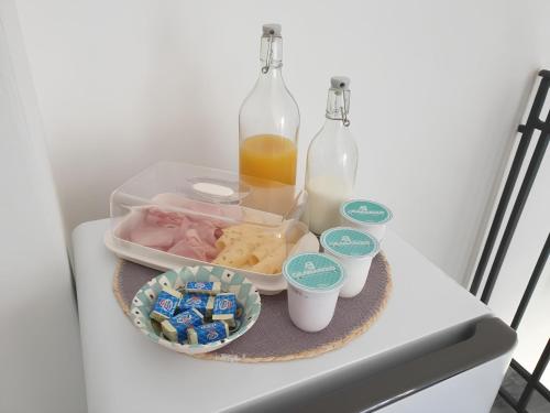 a tray with food and bottles on a table at Villa Bona in Termini Imerese