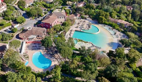 an aerial view of a resort with a pool and a beach at Les Restanques 2149 vue mer in Grimaud