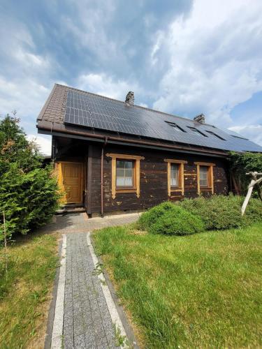 a house with solar panels on the roof at Pokoje Gościnne Grzegorz-2 in Białowieża