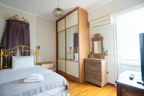 a bedroom with a bed and a dresser and a mirror at Psatha Villa's in Psatha