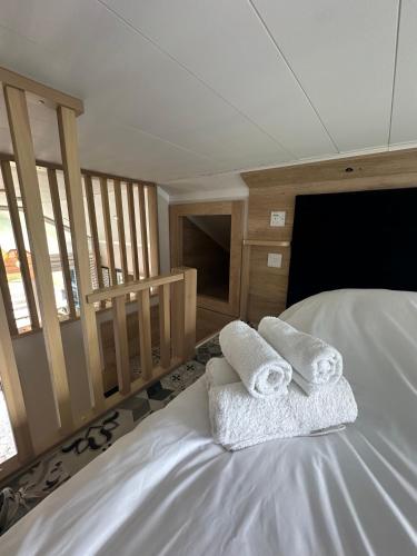 a bedroom with two towels on a bed at Self-Catering Lodge with Hot Tub in Inverness
