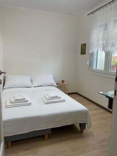 a bedroom with a bed with two towels on it at Mediterranean house in Skala Sotiros