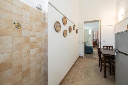 a kitchen and dining room with a table and a refrigerator at Palazzo Caputo in Nardò