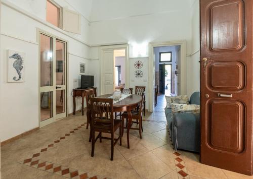 a dining room and living room with a table and chairs at Palazzo Caputo in Nardò
