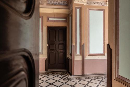 an empty hallway with a door and a window at Palazzo Caputo in Nardò