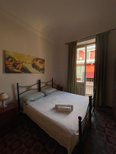 a bedroom with a large bed and a window at Il Tamburello in Floridia