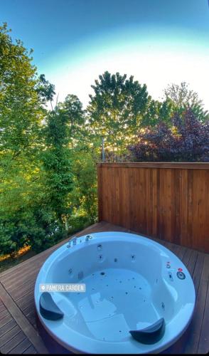a jacuzzi tub sitting on a deck with trees at Pamera Garden Hotel in Kılıçlı