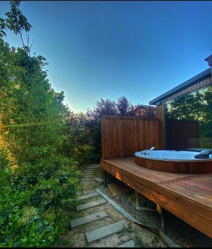 a bath tub sitting on top of a wooden deck at Pamera Garden Hotel in Kılıçlı
