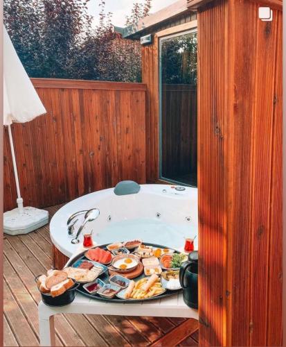 a bath tub with a tray of food in it at Pamera Garden Hotel in Kılıçlı