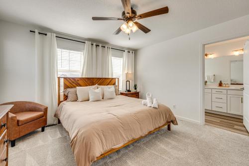 Un dormitorio con una cama grande con ventilador de techo. en Bright Colorado Springs Home, 10 Mi to Dtwn!, en Fountain