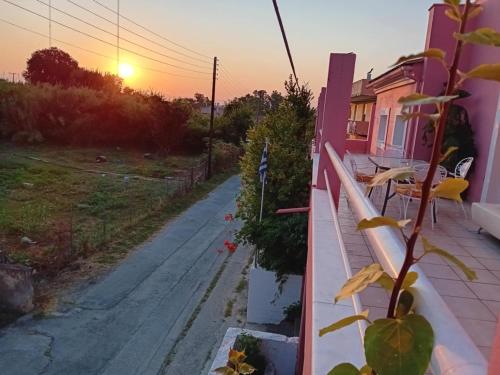 a view from the balcony of a house at sunset at Private Villa AKOBARA, 2km from city center in Corfu Town
