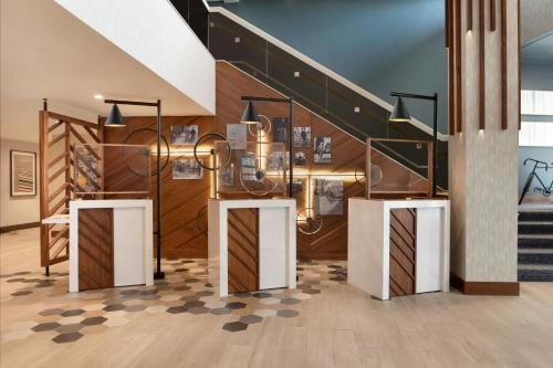 a lobby with a staircase and a stair case at Madison Marriott South in Madison