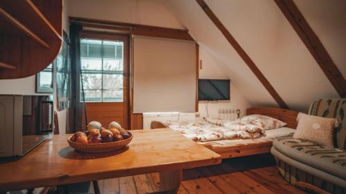 a room with a table with a bowl of fruit on it at Pokoje Gościnne Grzegorz-2 in Białowieża