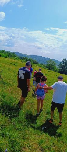 a group of people walking in a field at Pensiunea Soreanca in Costeşti