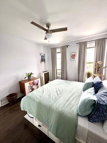 a bedroom with a bed and a ceiling fan at Sunny Jersey City 1BR, 25 min to NYC, 15min to EWR, King Bed, Hammock & Park Views in Jersey City