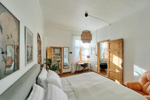 a bedroom with a bed and a desk in a room at Your Lutsu Apartment Lux Retro Prime Spot in Viljandi