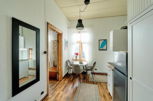 a kitchen with a table and a refrigerator and a window at Your Lutsu Apartment Lux Retro Prime Spot in Viljandi