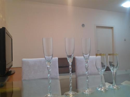 four wine glasses sitting on top of a table at Batajnica centar in Belgrade