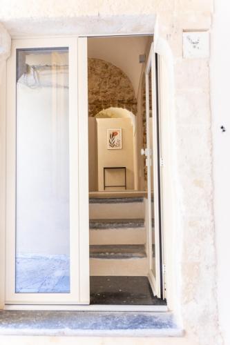 a door leading into a room with stairs at Dimora delle volte in Noto