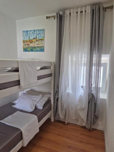 a room with two bunk beds and a window at LEMON TREE in Trogir