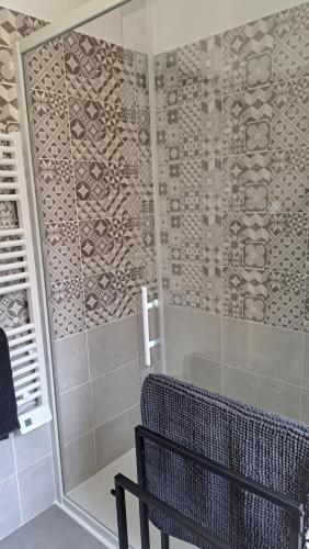 a shower with a glass door in a bathroom at LE SNOOKYBAY - Appartement Neuf - Classé 3 étoiles in Cavalaire-sur-Mer