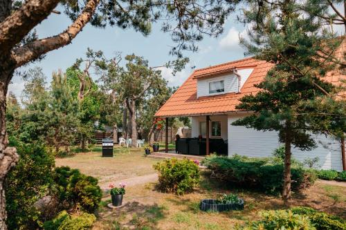 a house with an orange roof at Tu i teraz- Domek wypoczynkowy in Kamienica Królewska