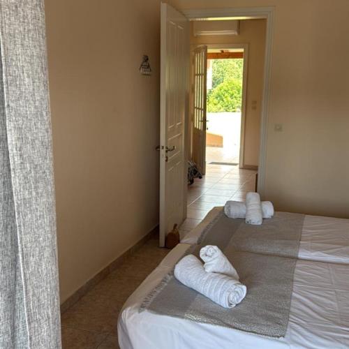 a bedroom with a bed with towels on it at Georgia's Apartments, Ipsos - Complex S in Ipsos