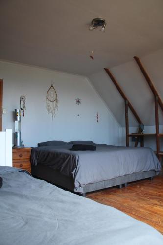 a bedroom with two beds in a attic at Surf Stoke Cottage in Jeffreys Bay