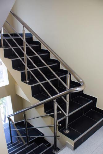 a metal staircase with black treads in a house at Hotel Catedral inn B SAS in Barranquilla