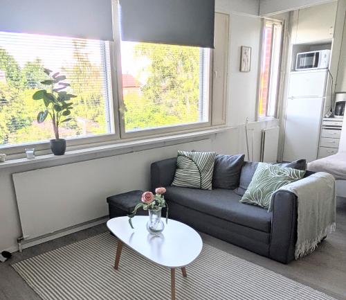 a living room with a couch and a table at Cozy apartment in Kemi City in Kemi