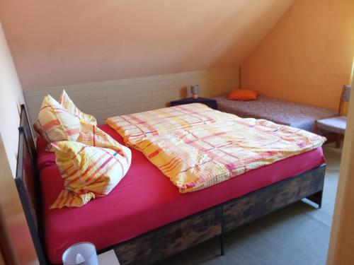 a bedroom with a bed and pillows on it at Haus Carmen in Falkenhain