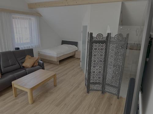a living room with a couch and a bed at Villa Racing - Privatzimmer in Spielberg in Spielberg