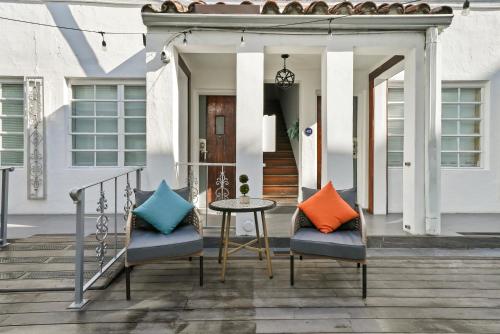 a porch with two chairs and a table at Chesterfield Hotel & Suites in Miami Beach