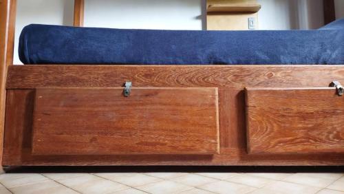 a wooden chest with a blue couch in a room at Get Up Hostel in Natal