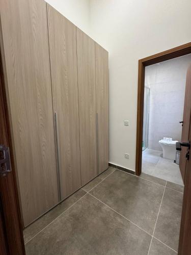 a room with wooden cabinets and a tile floor at Serene Living New 2 Bed in Taʼ Penza