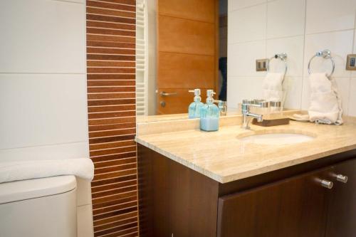 a bathroom with a sink and a mirror at HOM I Valle Nevado de Lujo 4D3B Ski in-out Piscina in Lo Barnechea