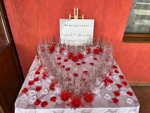 a table with wine glasses on top of it at Pensiunea Soreanca in Costeşti