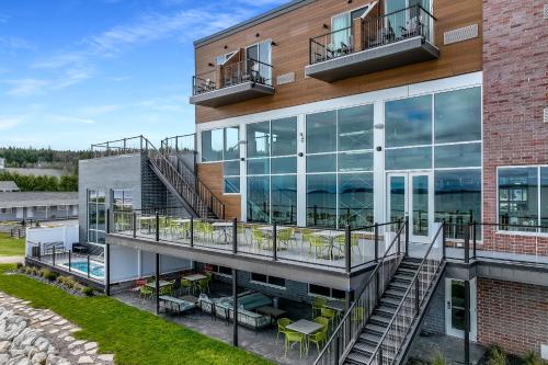 an apartment building with a balcony and stairs at Hampton Inn St Ignace Lakefront Mackinac in Evergreen Shores