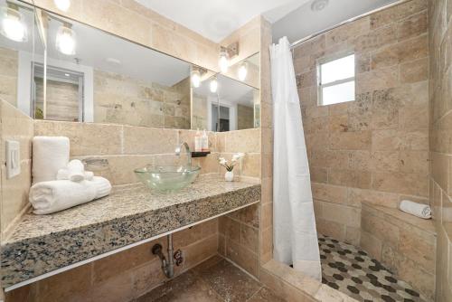 a bathroom with a sink and a shower at Chesterfield Hotel & Suites in Miami Beach