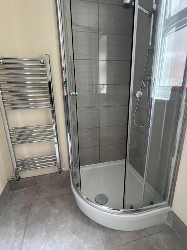 a shower with a glass door in a bathroom at Atherley Rooms in Southampton