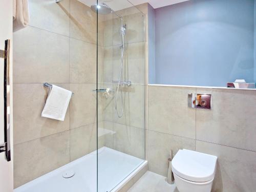a bathroom with a shower and a toilet at Novotel Wrocław Centrum in Wrocław
