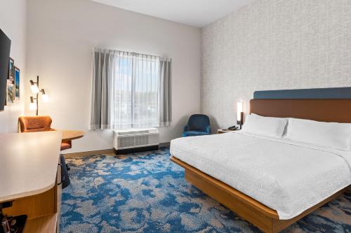 a hotel room with a bed and a desk at Hampton Inn St Ignace Lakefront Mackinac in Evergreen Shores