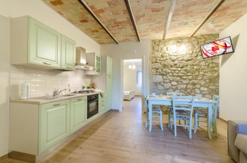 a kitchen with a table and chairs in a room at Agriturismo Tenuta Umberto I in Ripacorbaria