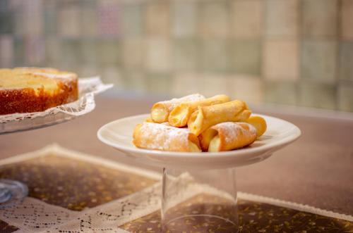 a plate of food on a table with a cake at Agriturismo Tenuta Umberto I in Ripacorbaria