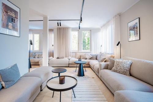 a living room with a couch and two tables at Ferienhaus Beatus ille in Kolpinsee