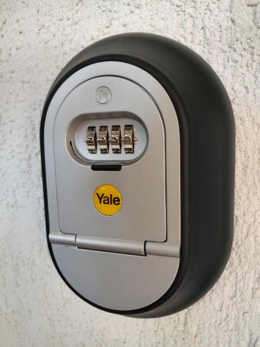 a lock on a door with a yellow sticker on it at Kve Apartment in Iaşi