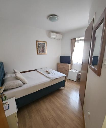 a small bedroom with a bed in a room at Pansion Most , Mostar in Mostar